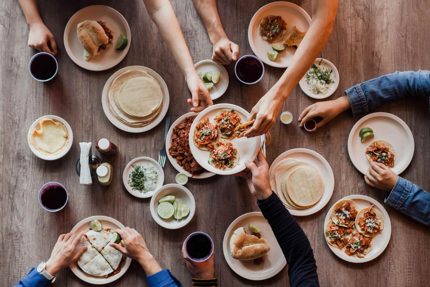 hands reaching for plates local restaurants near by lirica east austin apartments